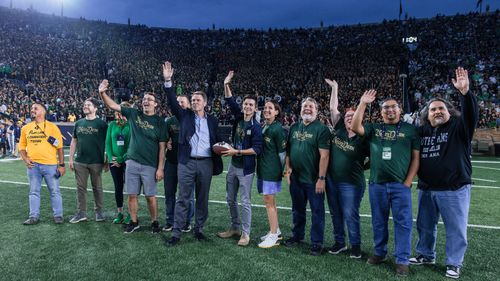 Hesburgh Libraries employees were honored with the rest of the AI Enablement team on the field during the Texas A&M game. 